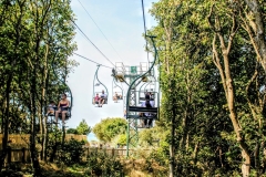 (AB 002) - Alum Bay - I love the strong contrast between the manmade chairlift structure and the soft surrounding foliage. The foliage frames the scene in a beautiful, softening way, leading the eye between the tree line. An example of perspective photography.