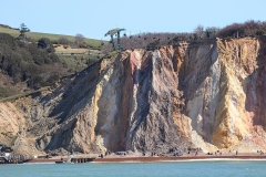 (AB 007) - Alum Bay - Very similar to the previous shot and once again only possible from a boat, illustrating the strong strata and coloured rock/sand beneath, but this time with the chair lift structure up on the hill.