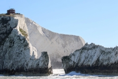 (TN 006) - The Needles - This iconic photo of The Needles, excluding the Lighthouse and taken from a different angle, illustrates the fragile structure of the remaining rock and the old battery perched on top of the cliff edge.