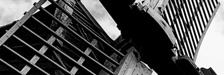 (BW001) - Bembridge Windmill - I really like the strong contrast, texture and Shapes in this angle I saw the Windmill from. Showing the detailed wood grain in contrast to straight structure of the sails. I felt this shot benefits by being turned into monochrome to help emphasis the textures, shapes. During my photographic journey I have taken learnings from other photographers like Ansel Adam, the negative, empty space in this shot is as important as the item being photographed.